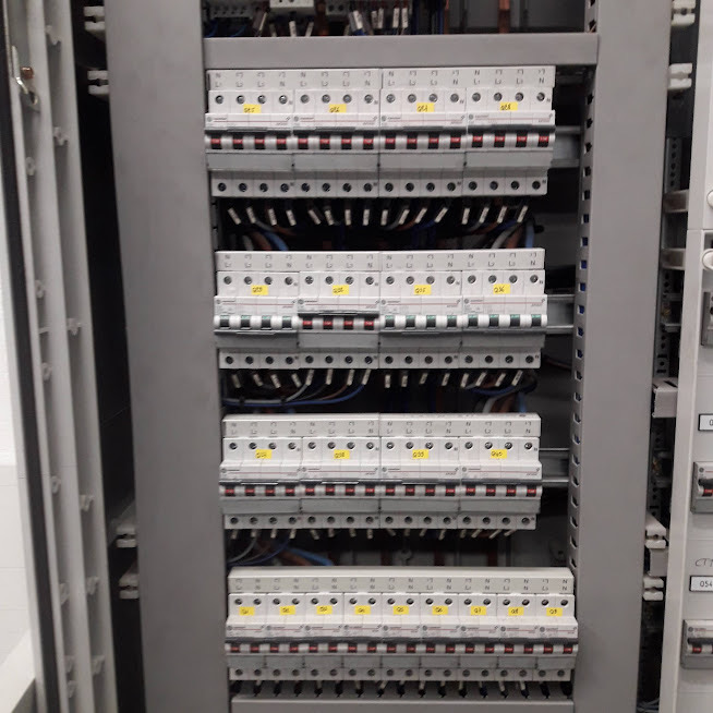 A newly installed consumer unit in an East London property, four rows of neatly labelled circuit breakers with tidy blue and red wiring, fitted by Hi Elec-Tech Solutions.