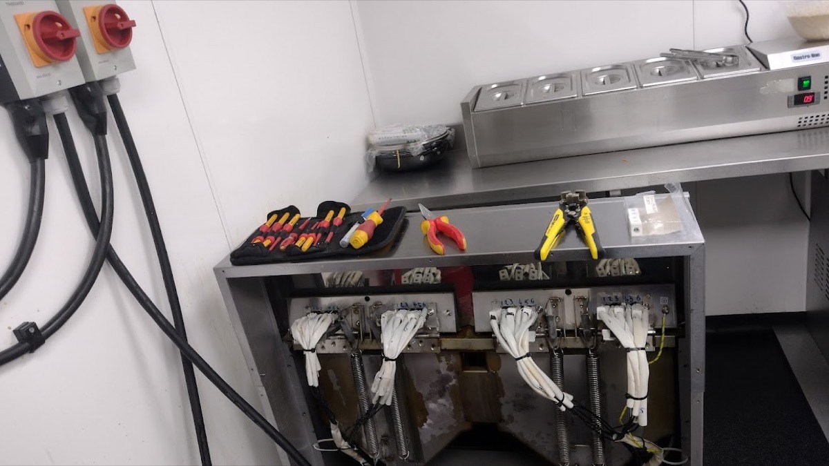Commercial kitchen electrical work in East London, rotary isolators wired to catering equipment with a set of insulated VDE hand tools laid out ready, by Hi Elec-Tech Solutions.