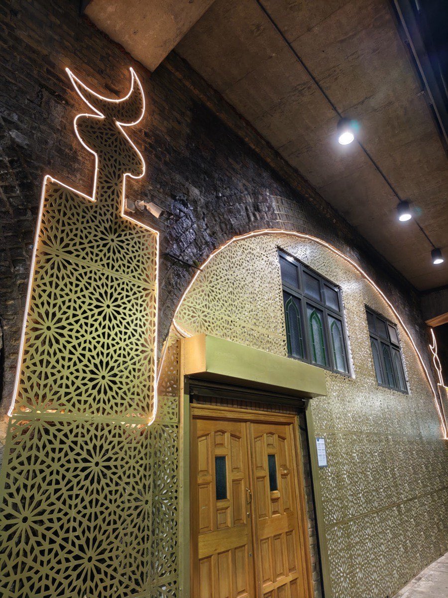 Illuminated shopfront signage and laser-cut lit screens on a brick railway-arch frontage in East London, powered and installed by Hi Elec-Tech Solutions.